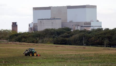 A tractor mows a field on the site where EDF Energy's Hinkley Point C nuclear power station will be constructed in Bridgwater, southwest England October 24, 2013. REUTERS/Suzanne Plunkett/File Photo