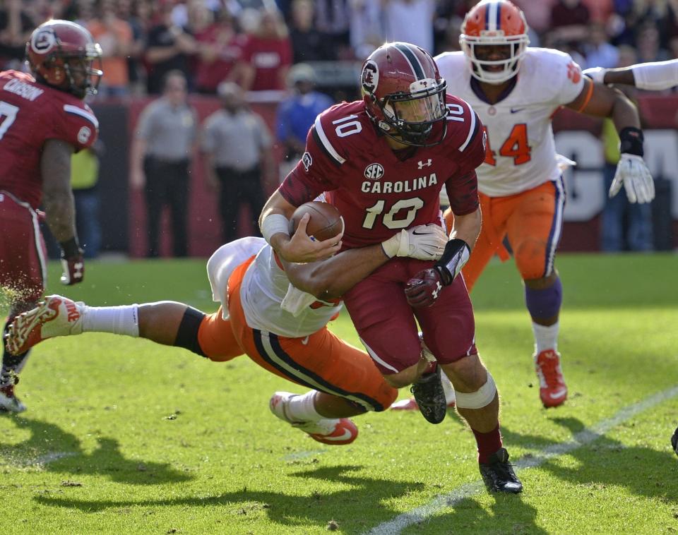 South Carolina quarterback Perry Orth scrambles out of the backfield during the second half of an NCAA college football game against Clemson Saturday, Nov. 28, 2015, in Columbia, S.C. Clemson won 37-32. (AP Photo/Richard Shiro)