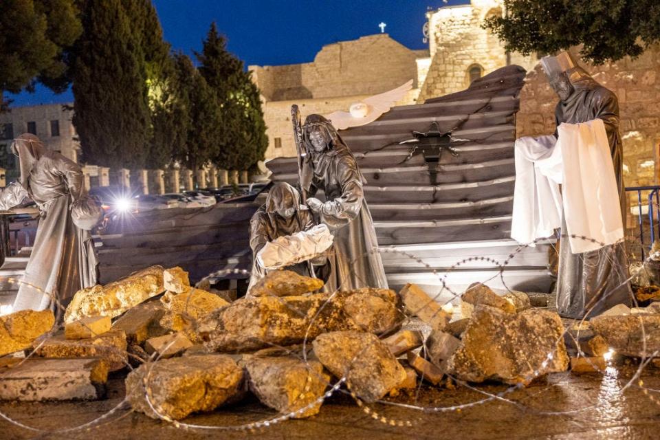 "Nativity under the Rubble" by Palestinian artist Tariq Salsa is seen in Manger Square near the Church of Nativity in Bethlehem