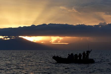 Rescue team members stand on a rubber boat during a search for missing passengers after a ferry sank last week in Lake Toba in Simalungun, North Sumatra, Indonesia, June 27, 2018. Picture taken June 27, 2018. Antara Foto/Sigid Kurniawan/via REUTERS