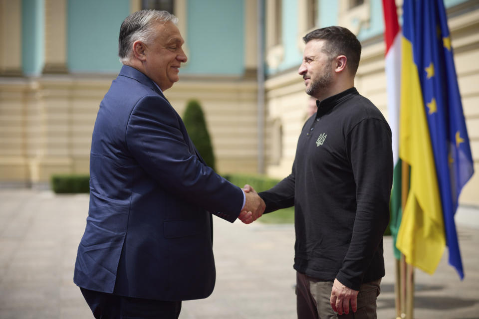 In this photo provided by the Ukrainian Presidential Press Office, Ukrainian President Volodymyr Zelenskyy, right, welcomes Hungarian Prime Minister Viktor Orban in Kyiv, Ukraine, Tuesday, July 2, 2024. (Ukrainian Presidential Press Office via AP)