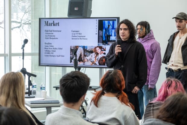 A senior design student explaining their senior collection in front of students and a jury of industry professionals.<p>Photo: Courtesy of Kent State University</p>