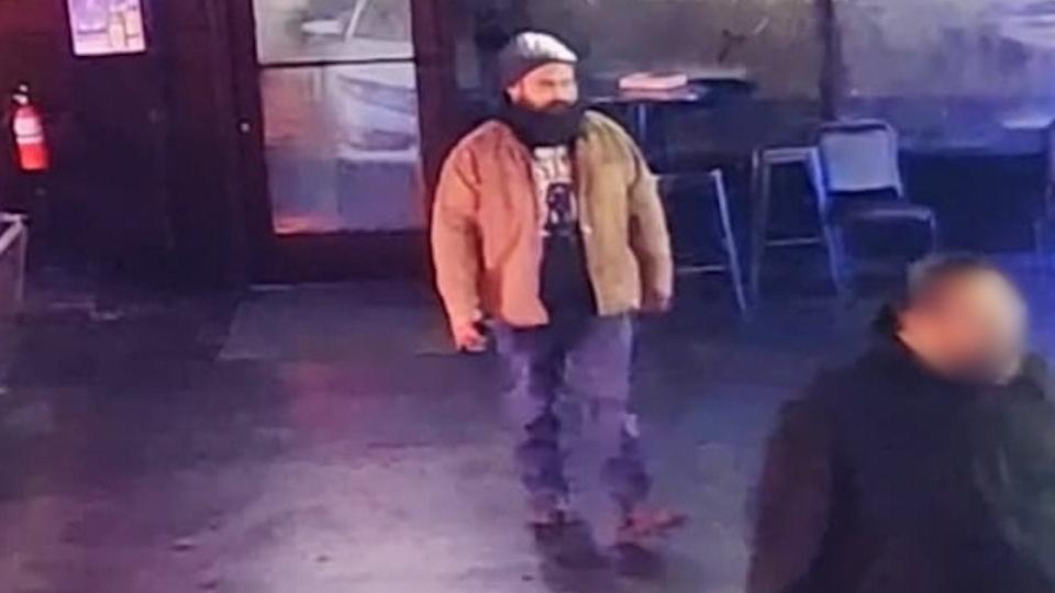 A security camera image shows a bearded man, later identified as Ricardo Llamas, suspected of shooting a person in a car outside Bad Habits Bar & Grill on Nov. 22.