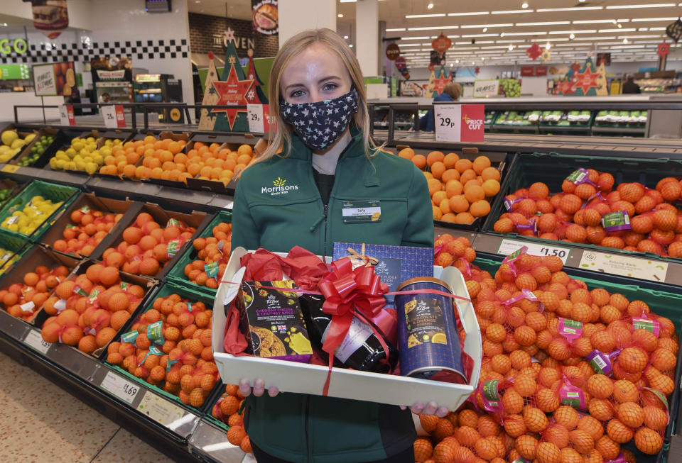 Staff member Sally O'Hara helps launch the Morrisons Acts of Community Kindness campaign. Photo: PA