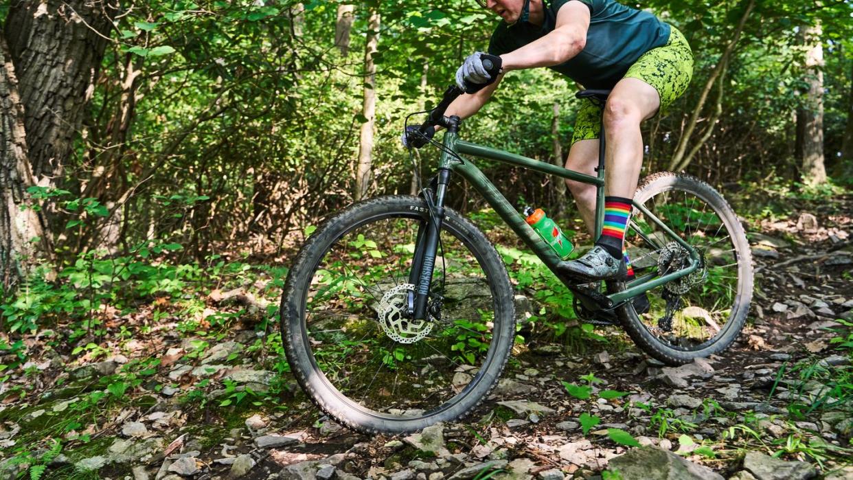 riding specialized rockhopper elite 29 mountain bike on trail