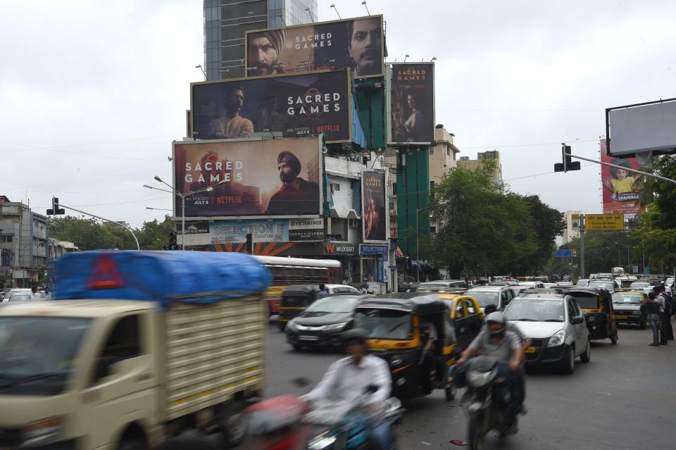 Commuters in Mumbai travel past large billboards for "Sacred Games," India's first Netflix original series,&nbsp;on Wednesday.&nbsp; (Photo: INDRANIL MUKHERJEE via Getty Images)
