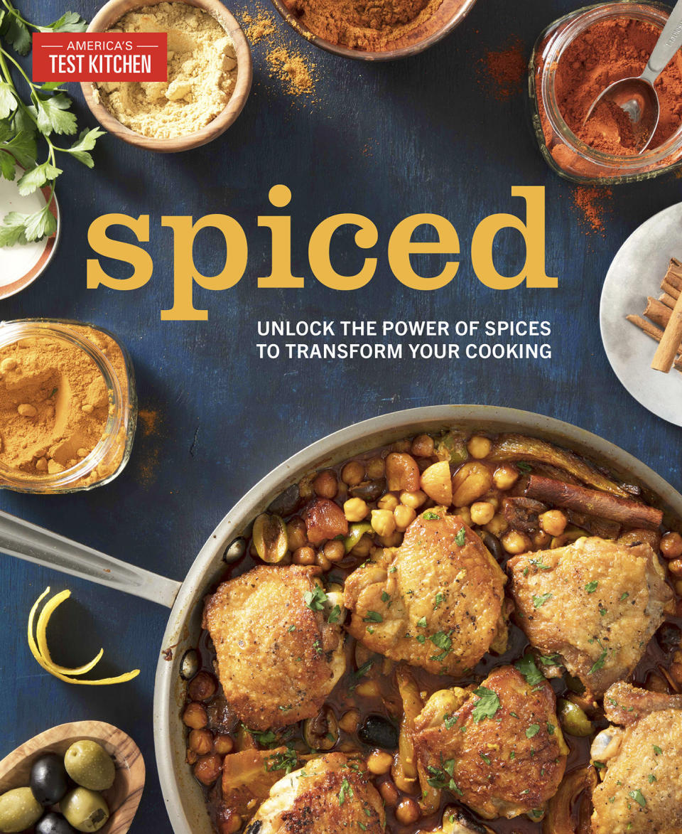 This image provided by America's Test Kitchen in May 2019 shows the cover for the cookbook “Spiced.” It includes a recipe for Crispy Salt and Pepper Shrimp. (America's Test Kitchen via AP)