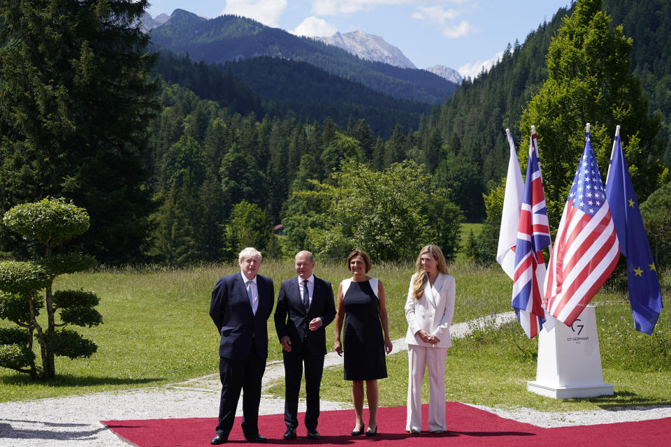 British Prime Minister Boris Johnson, left, and his wife Carrie Johnson, right, talk with German Chancellor Olaf Scholz and Britta Ernst, Minister of Education, Youth, and the Federal State of Bradenburg, at the G7 Summit in Elmau, Germany, Sunday, June 26, 2022, during an arrival ceremony. (AP Photo/Susan Walsh, Pool)