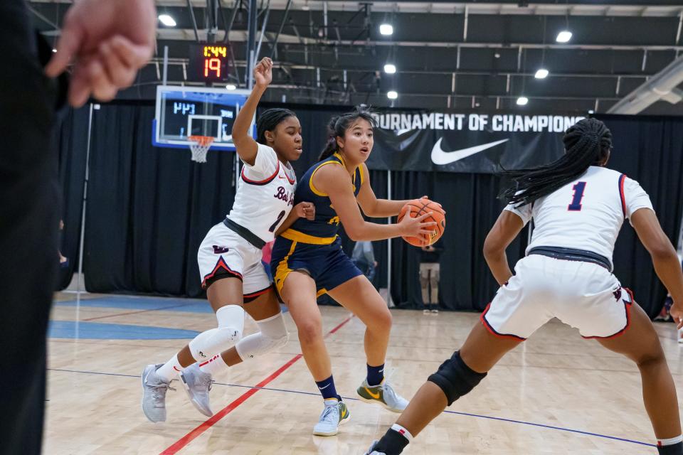 Aila Kaibara (14) of Phoenix Country Day School looks to pass the ball, guarded by Sloan Williams (2) and Janiyah Bone (1) of the Bob Jones Patriots during a game at the Nike Tournament of Champions at Legacy Sports Park on Dec. 18, 2023, in Mesa, AZ.