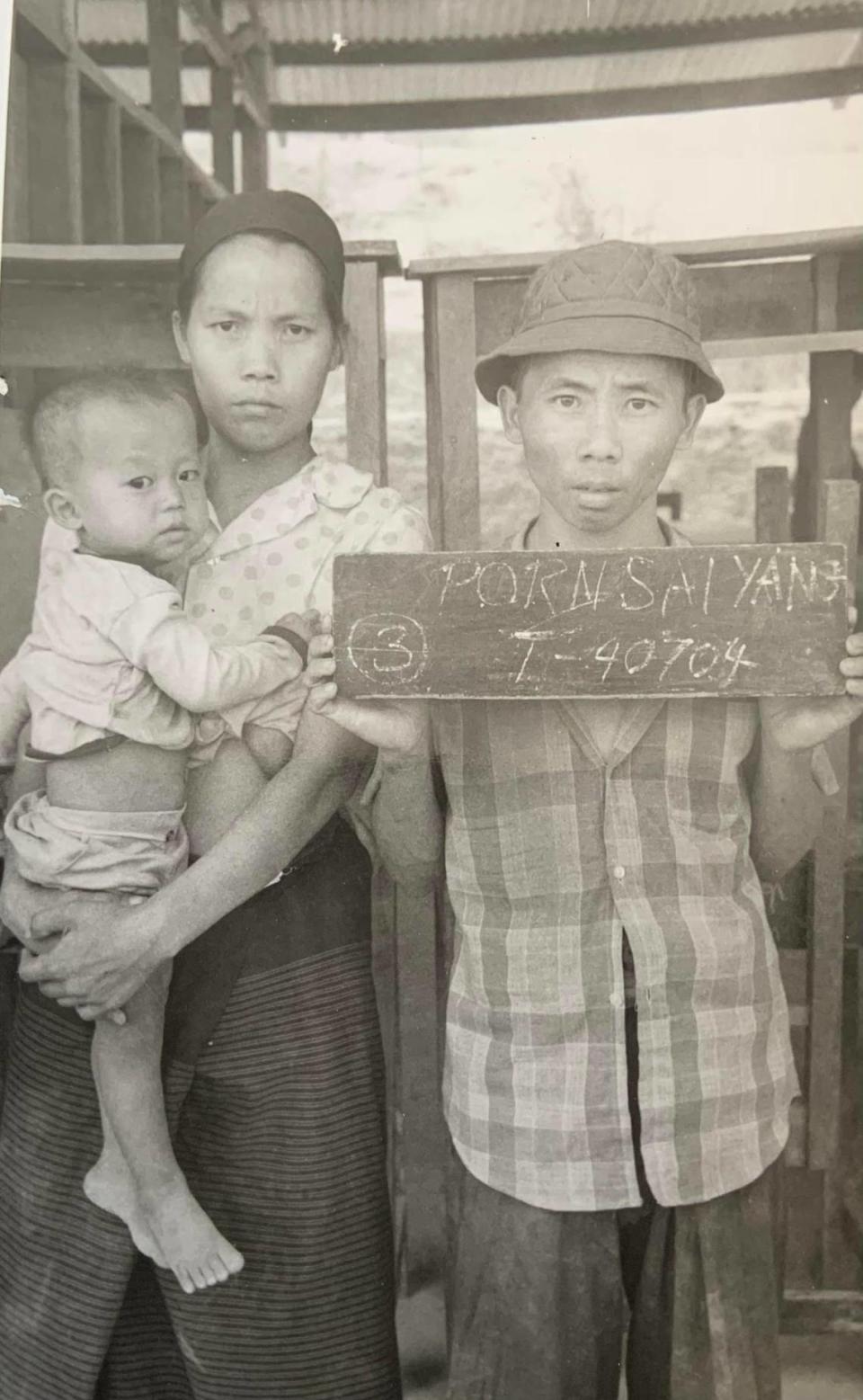 Seen here is an undated photo Jue Vang, left, holding her eldest child Cheng Yang and standing next to her husband Wa Pao Yang, who died in 2022. Wa Pao Yang served as a second lieutenant in Lao guerrilla forces fighting alongside the CIA in the “secret war” in Laos during the Vietnam War.