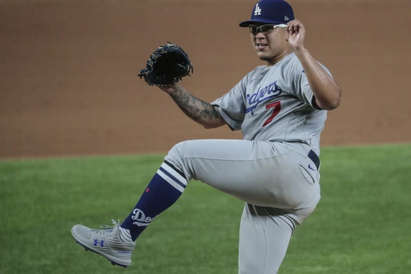 Arlington, Texas, Thursday October 8, 2020. Los Angeles Dodgers starting pitcher Julio Urias (7) follows through as he strikes out San Diego Padres second baseman Jake Cronenworth (9) to end the fourth inning in game three of the NLDS at Globe Life Field. (Robert Gauthier/ Los Angeles Times)