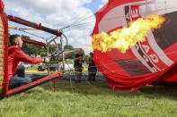 <p>Hot air Balloons are being tethered as balloonists prepare to launch at the Bristol international balloon fiesta held on August 10, 2017 in Avon, England. (Photo: Amer Ghazzal/Barcroft Images) </p>