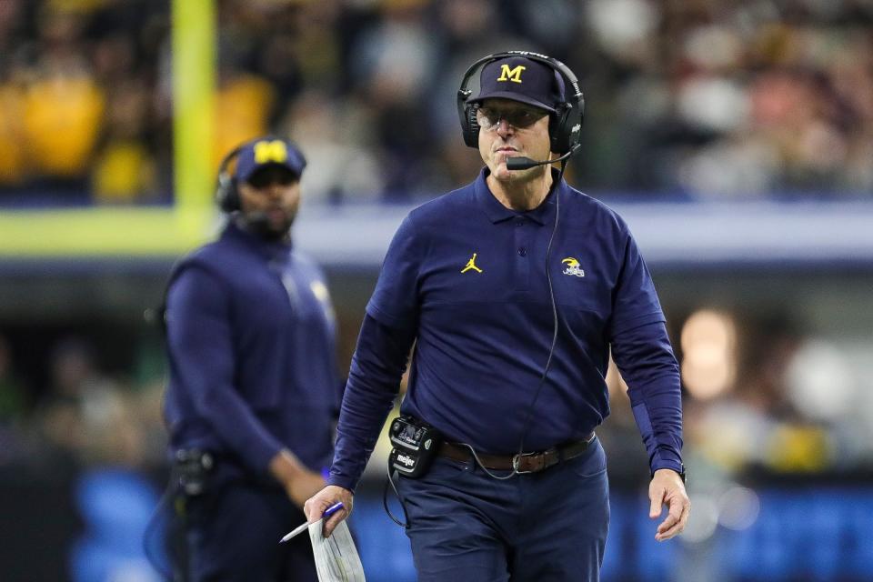 Michigan coach Jim Harbaugh walks on the field during the first half of the 2023 Big Ten championship game against Iowa at Lucas Oil Stadium in Indianapolis, Ind. on Saturday, Dec. 2, 2023.