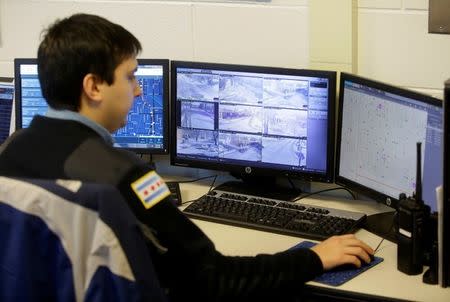 Chicago Police Officer Grand monitors the Police Observation Devices on computer screens at the 7th District police station in Chicago, Illinois, U.S. January 5, 2018. REUTERS/Joshua Lott