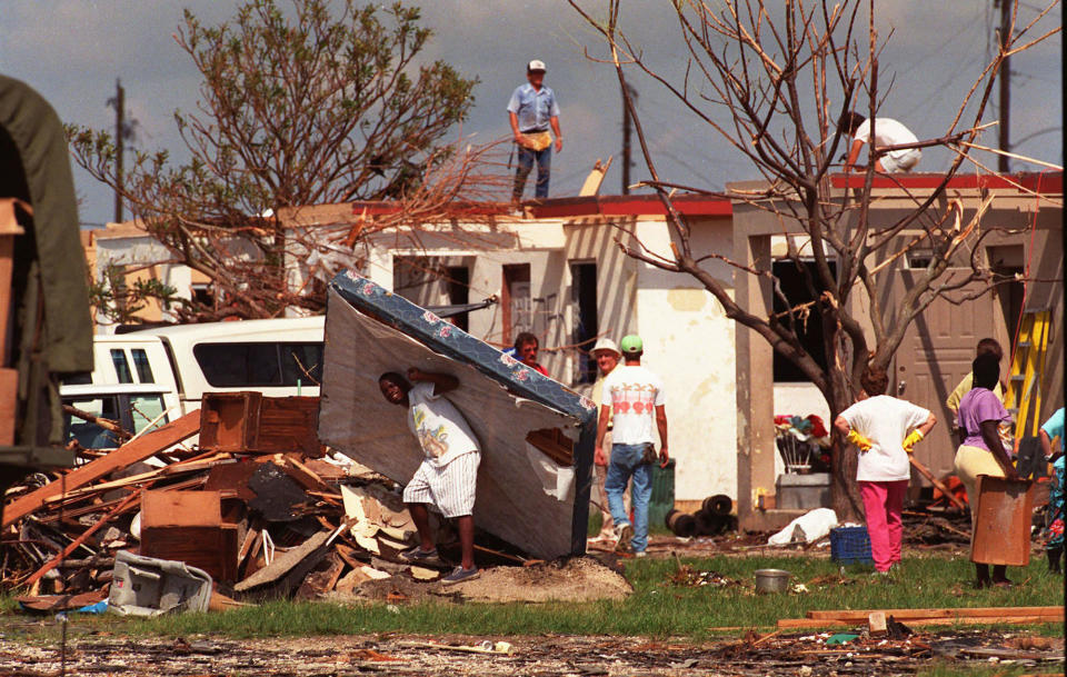 <p>A Mormon church group helps Florida City, Fla. residents clear debris and build roofs in this Aug. 29 1992 file photo, as cleanup continued after Hurricane Andrew moved through the area. (AP Photo/ Lynne Sladky, File) </p>