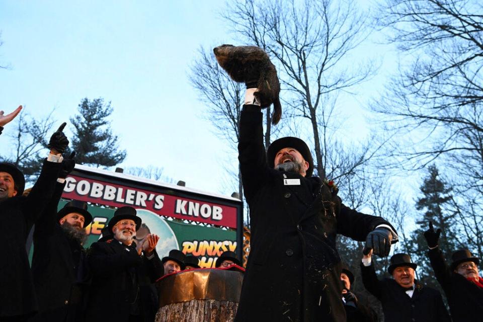 Groundhog Club handler A.J. Dereume holds Punxsutawney Phil, the weather prognosticating groundhog, during the 136th celebration of Groundhog Day on Gobbler's Knob in Punxsutawney, Pa., Wednesday, Feb. 2, 2022. Phil's handlers said that the groundhog has forecast six more weeks of winter. (AP Photo/Barry Reeger)