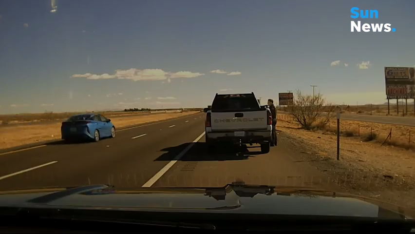 New Mexico State Policeman Darian Jarrott pulls over Omar Cueva on a traffic violation along Interstate 10 east of Deming on Feb. 4, 2021.