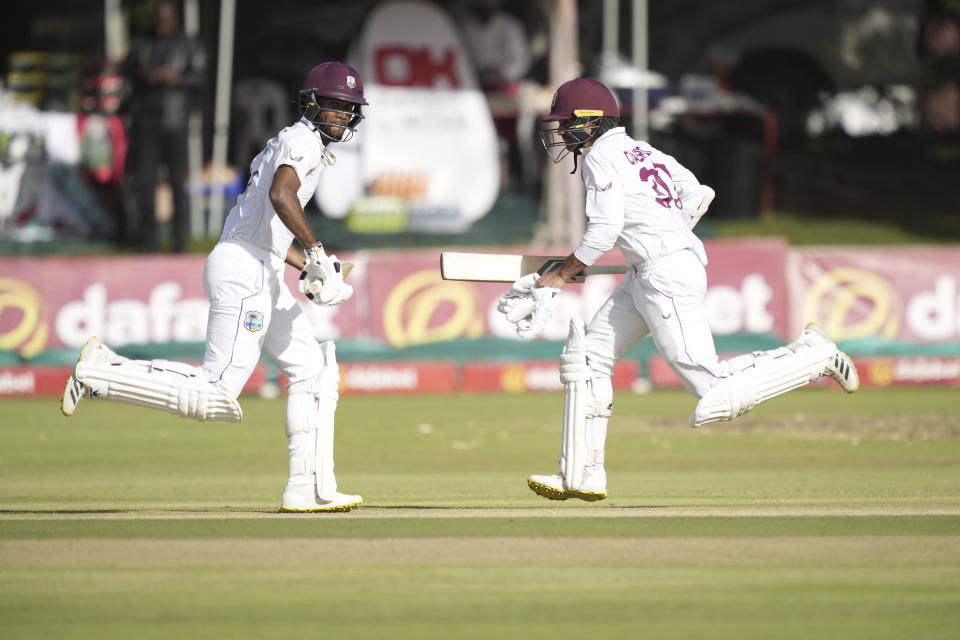 West Indies batsman Tagenarine Chanderpaul,right, and Kraigg Brathwaite make a run on the second day of the Test cricket match between Zimbabwe and West Indies at Queens Sports Club in Bulawayo, Zimbabwe, Sunday,Feb, 5, 2023. (AP Photo/Tsvangirayi Mukwazhi)