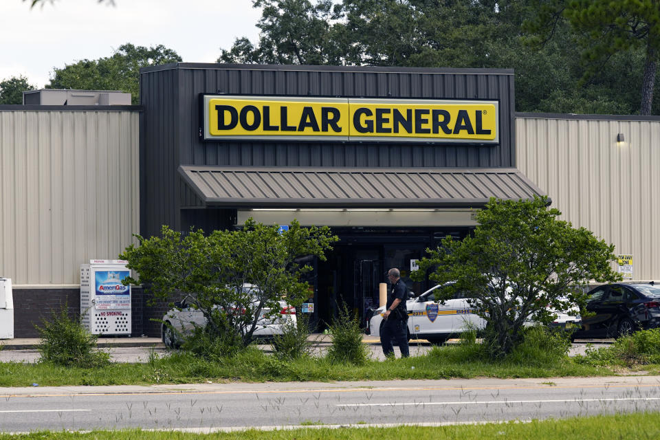 Law enforcement officials continue their investigation at a Dollar General Store that was the scene of a mass shooting, Sunday, Aug. 27, 2023, in Jacksonville, Fla. (AP Photo/John Raoux)