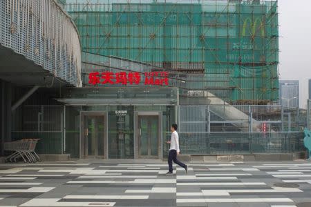 A man walks past a logo of Lotte Mart in Beijing, China September 14, 2017. Picture taken September 14, 2017. REUTERS/Stringer