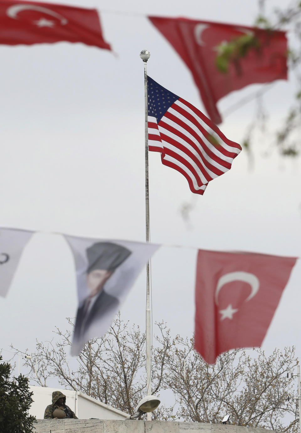 Turkish flags and banners depicting Mustafa Kemal Ataturk, the founder of modern Turkey, decorate a street outside the United States embassy in Ankara, Turkey, Sunday, April 25, 2021. Turkey's foreign ministry has summoned the U.S. Ambassador in Ankara to protest the U.S. decision to mark the deportation and killing of Armenians during the Ottoman Empire as "genocide." On Saturday, U.S. President Joe Biden followed through on a campaign promise to recognize the events that began in 1915 and killed an estimated 1.5 million Ottoman Armenians as genocide. (AP Photo/Burhan Ozbilici)