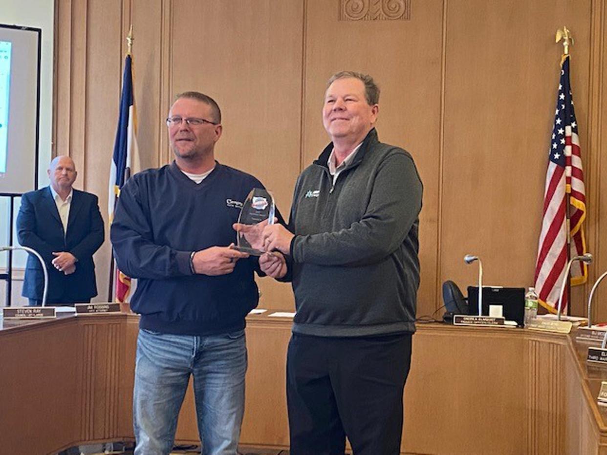 Boone mayor John Slight, left, accepts a BEST of Iowa Excellence Award from David Vollmar, senior key account manager for Alliant Energy and Alliant’s representative on the BEST Board.