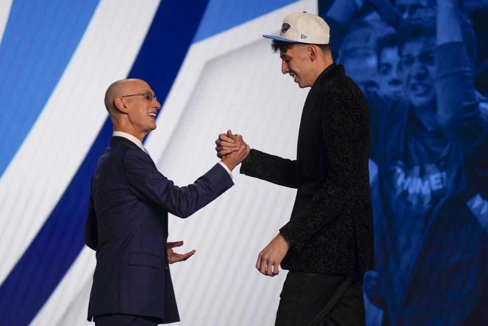 Chet Holmgren, right, is congratulated by NBA Commissioner Adam Silver after being selected second overall in the NBA basketball draft by the Oklahoma Thunder, Thursday, June 23, 2022, in New York. (AP Photo/John Minchillo)