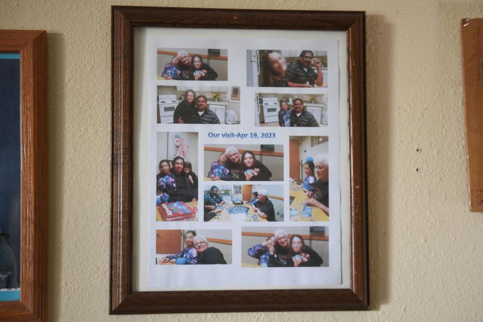 A framed photo collage of Christian Banley’s family visiting J and L in the group home they were living in at the time is hung from the wall of Thad and Pam Banley’s house on Wednesday, Aug. 23, 2023. This was one of the family's most recent visits with the girls. The girls' faces are distorted to protect their image and identity.