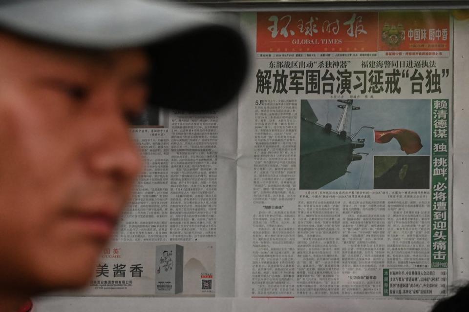 A Chinese newspaper front page shows news coverage of China’s military drills around Taiwan, in Beijing (AFP via Getty Images)