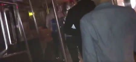Passengers evacuate from a train in the dark following a subway train incident in the Manhattan borough of New York, United States June 27, 2017, in this still image taken from a video obtained from social media. Twitter/@cutdekProd/via REUTERS