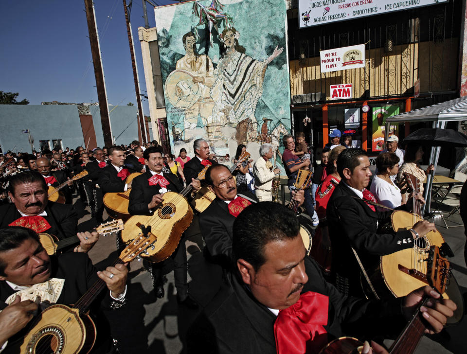 FILE - Mariachis participate in the annual Mariachi procession and Mass in the Boyle Heights selection of Los Angeles, Tuesday, Nov. 24, 2009. With the blasting of trumpets and the strumming of guitars, the U.S. Postal Service is celebrating the release of a new series of stamps honoring the traditional Mexican genre of mariachi. The first-day-of-issue ceremony was held Friday, July 15, 2022, in New Mexico's largest city during the 30th annual Mariachi Spectacular de Albuquerque. (AP Photo/Richard Vogel, File)