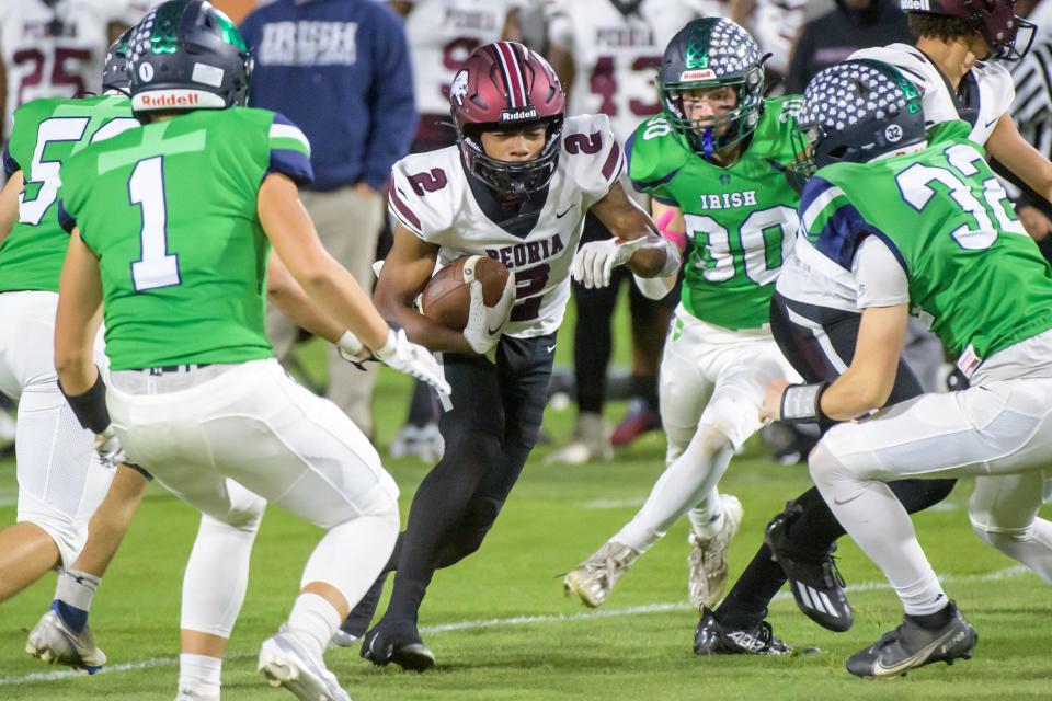 The Peoria Notre Dame defense closes in on Peoria High's TQ Webb in the first half of their Week 9 football game Friday, Oct. 20, 2023 at Dozer Park in Peoria.