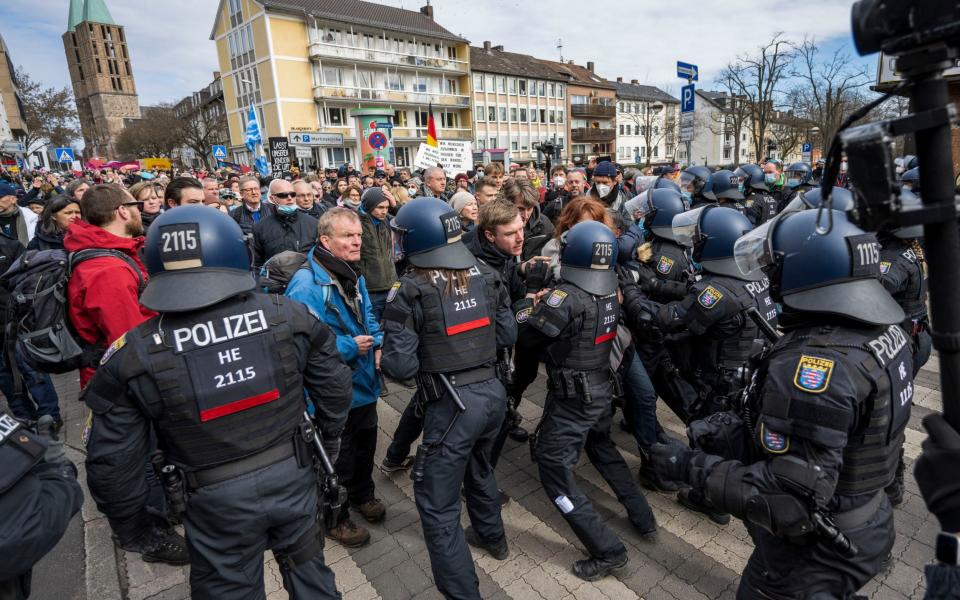 People clash with police officers as they protest against ongoing lockdown measures -  Thomas Lohnes/ Getty Images Europe