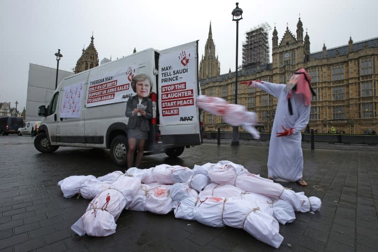 Demonstrators wearing masks depicting Britain's Prime Minister Theresa May and Saudi Arabia's Crown Prince Mohammed bin Salman protested outside the Houses of Parliament