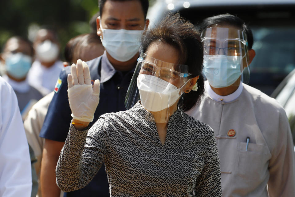 Myanmar leader Aung San Suu Kyi wearing protective face mask and shield waves to supporters as she leaves a demonstration of the voting for upcoming Nov. 8 general election, Tuesday, Oct. 20, 2020, in Naypyitaw, Myanmar. (AP Photo/Aung Shine Oo)