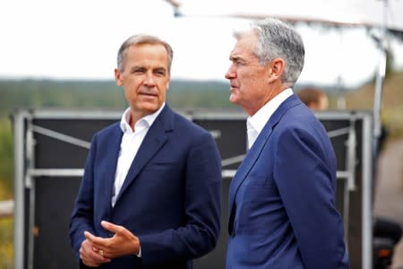 Federal Reserve Chair Jerome Powell and Governor of the Bank of England, Mark Carney chat during the three-day "Challenges for Monetary Policy" conference in Jackson Hole, Wyoming
