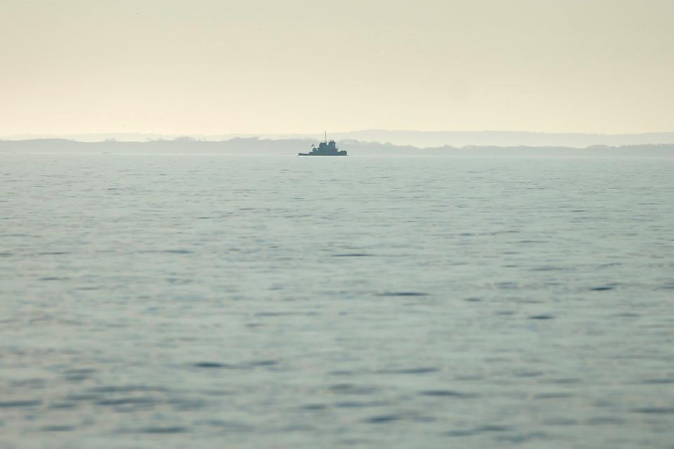 A small tugboat makes its way across Buzzards Bay as seen from East Beach Road in Westport.