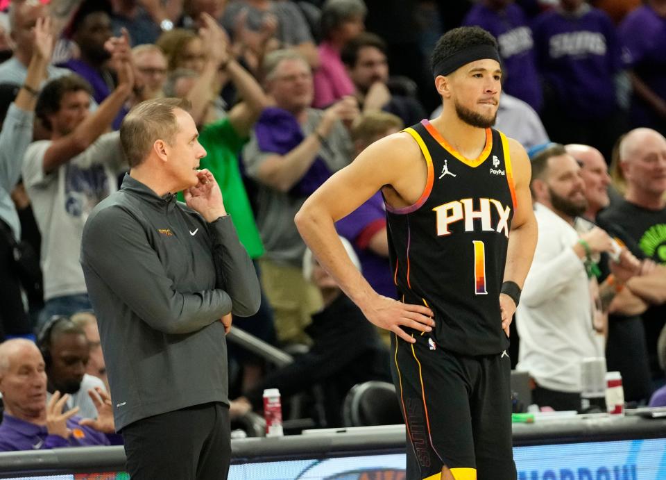 Phoenix Suns head coach Frank Vogel and guard Devin Booker wait out the final seconds of their 122-116 loss to the Minnesota Timberwolves in game 4 of the Western Conference first round series at Footprint Center on Sunday, April 28, 2024.