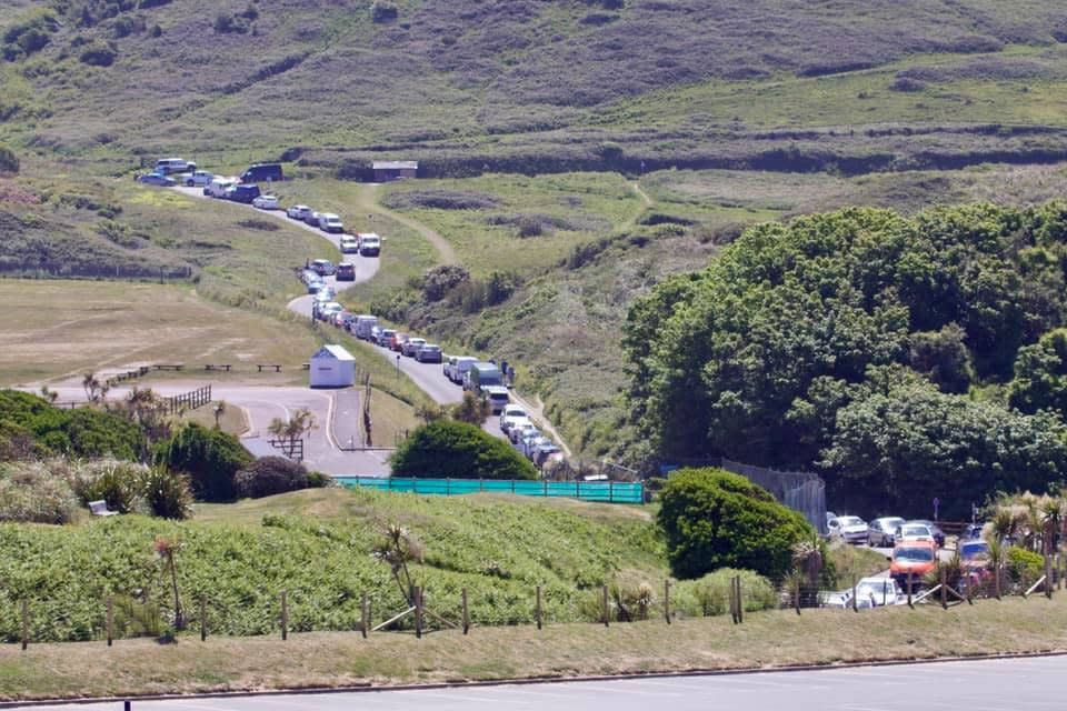 Traffic on the approach to Woolacombe, Devon. See SWNS story SWPLbeach. Sun-seekers have been flocking to coastal hot-spots in the Westcountry in such numbers traffic wardens have reportedly run out of TICKETS. Several routes into beaches in Devon have been left clogged with traffic with roads described as "exceptionally busy." Cops say several beach car parks had to be closed as people flocked to the seaside to take advantage of the hottest day of the year. Warnings had been issued urging people to stay away despite the lifting of lockdown restrictions.    