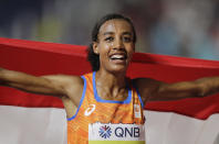 Sifan Hassan of the Netherlands celebrates winning the gold medal in the women's 10,000m final at the World Athletics Championships in Doha, Qatar, Saturday, Sept. 28, 2019. (AP Photo/Petr David Josek)