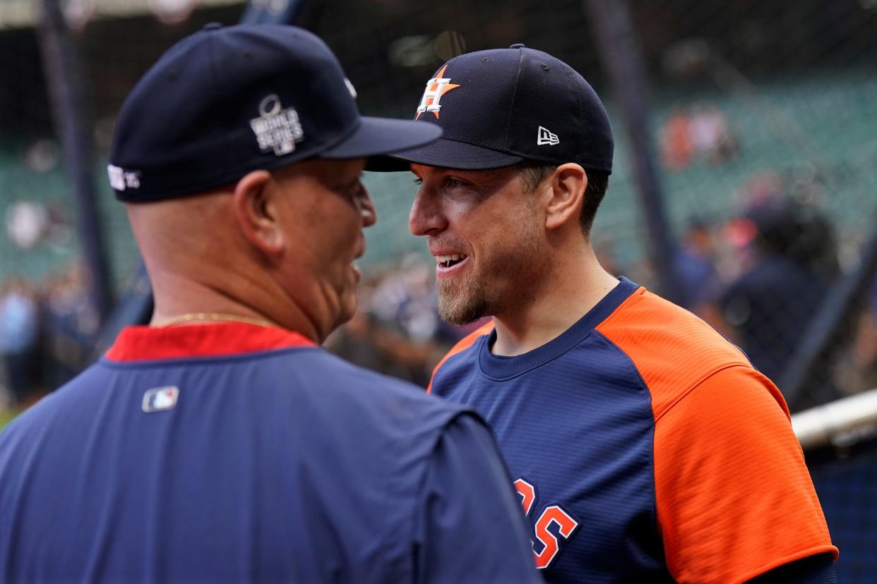 Atlanta Braves manager Brian Snitker and Houston Astros hitting coach Troy Snitker talk before Game 6 of baseball's World Series between the Houston Astros and the Atlanta Braves Tuesday, Nov. 2, 2021, in Houston. (AP Photo/David J. Phillip)