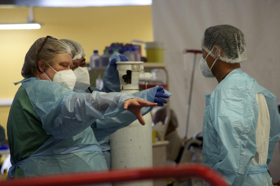 Nurses speak at the emergency service of the hospital in Papeete, Tahiti island, French Polynesia, Friday Aug.20, 2021. France's worst virus outbreak so far is unfolding 12 times zones away from Paris, devastating Tahiti and the idyllic atolls of French Polynesia. It's France's latest challenge in juggling resources to battle the pandemic in former colonies that stretch around the world (AP Photo/Esther Cuneo)