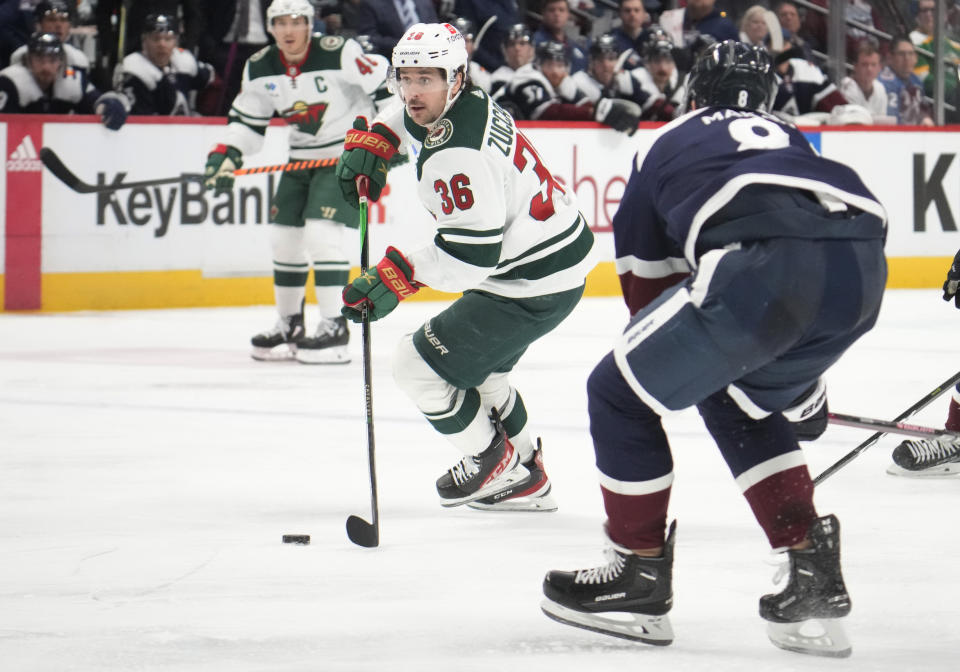 Minnesota Wild right wing Mats Zuccarello, back, drives past Colorado Avalanche defenseman Cale Makar in the second period of an NHL hockey game, Wednesday, March 29, 2023, in Denver. (AP Photo/David Zalubowski)