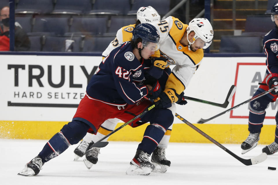 Nashville Predators' Alexandre Carrier, right, and Columbus Blue Jackets' Alexandre Texier fight for the puck during the second period of an NHL hockey game Monday, May 3, 2021, in Columbus, Ohio. (AP Photo/Jay LaPrete)