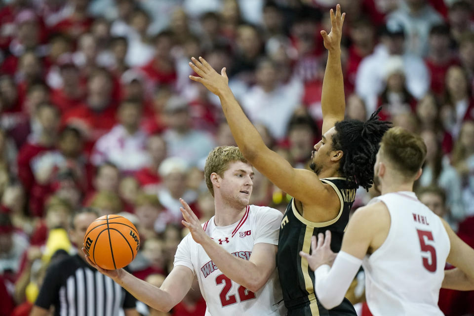 Wisconsin's Steven Crowl (22) drives against Purdue's Trey Kaufman-Renn (4) during the first half of an NCAA college basketball game Sunday, Feb. 4, 2024, in Madison, Wis. (AP Photo/Andy Manis)