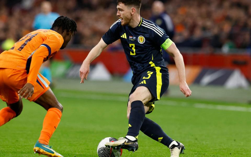 Andy Robertson runs at Jeremie Frimpong