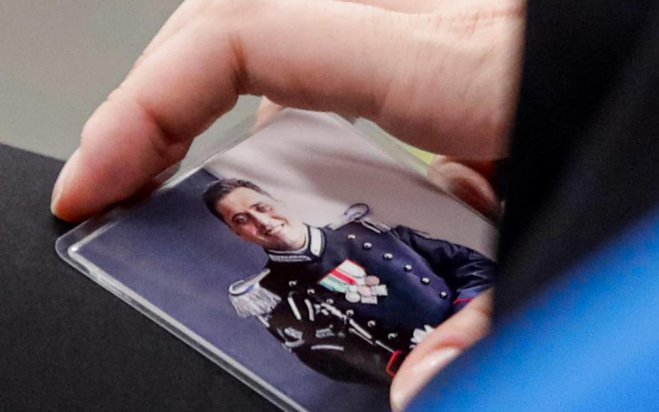 Rosa Maria Esilio, widow of Italian Carabinieri paramilitary police officer Mario Cerciello Rega, holds a photograph of her husband - Alessandra Tarantino /AP
