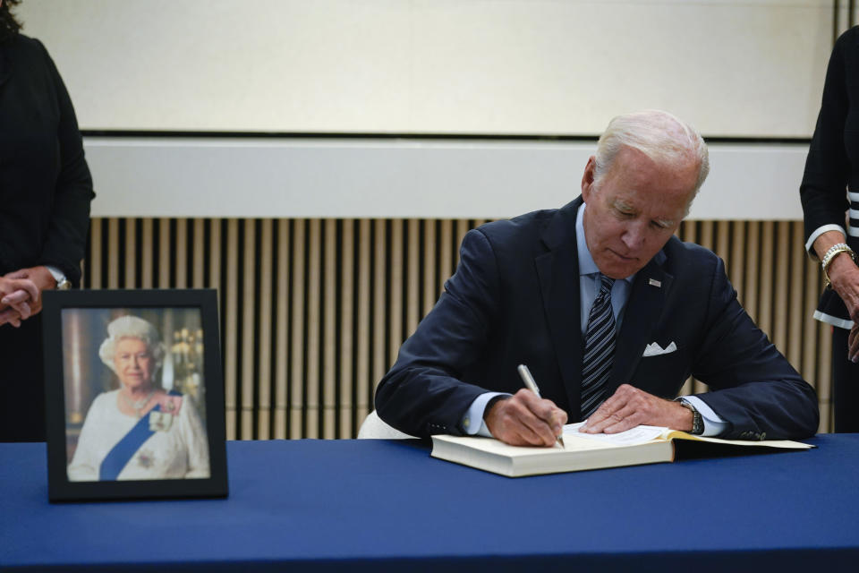 President Joe Biden signs a condolence book at the British Embassy in Washington, Thursday, Sept. 8, 2022, for Queen Elizabeth II, Britain's longest-reigning monarch and a rock of stability across much of a turbulent century, who died Thursday after 70 years on the throne. She was 96. (AP Photo/Susan Walsh)