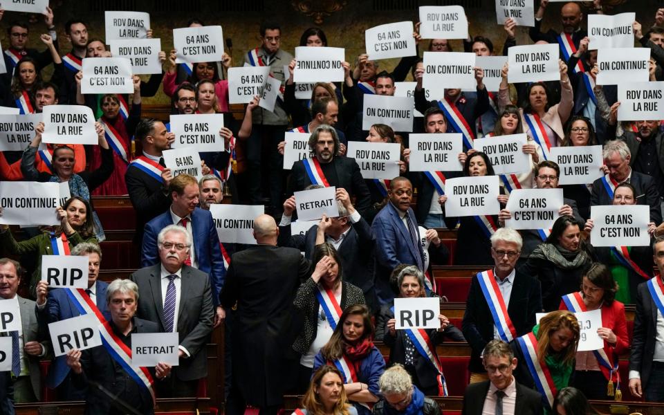 Left-wing MPs protest against the pension reform in the French National Assembly on Monday - Lewis Joly/AP