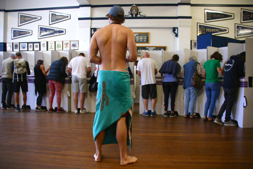 At the Bondi surf club a voter dressed in a towel waits in line to cast his ballot. Source: Getty